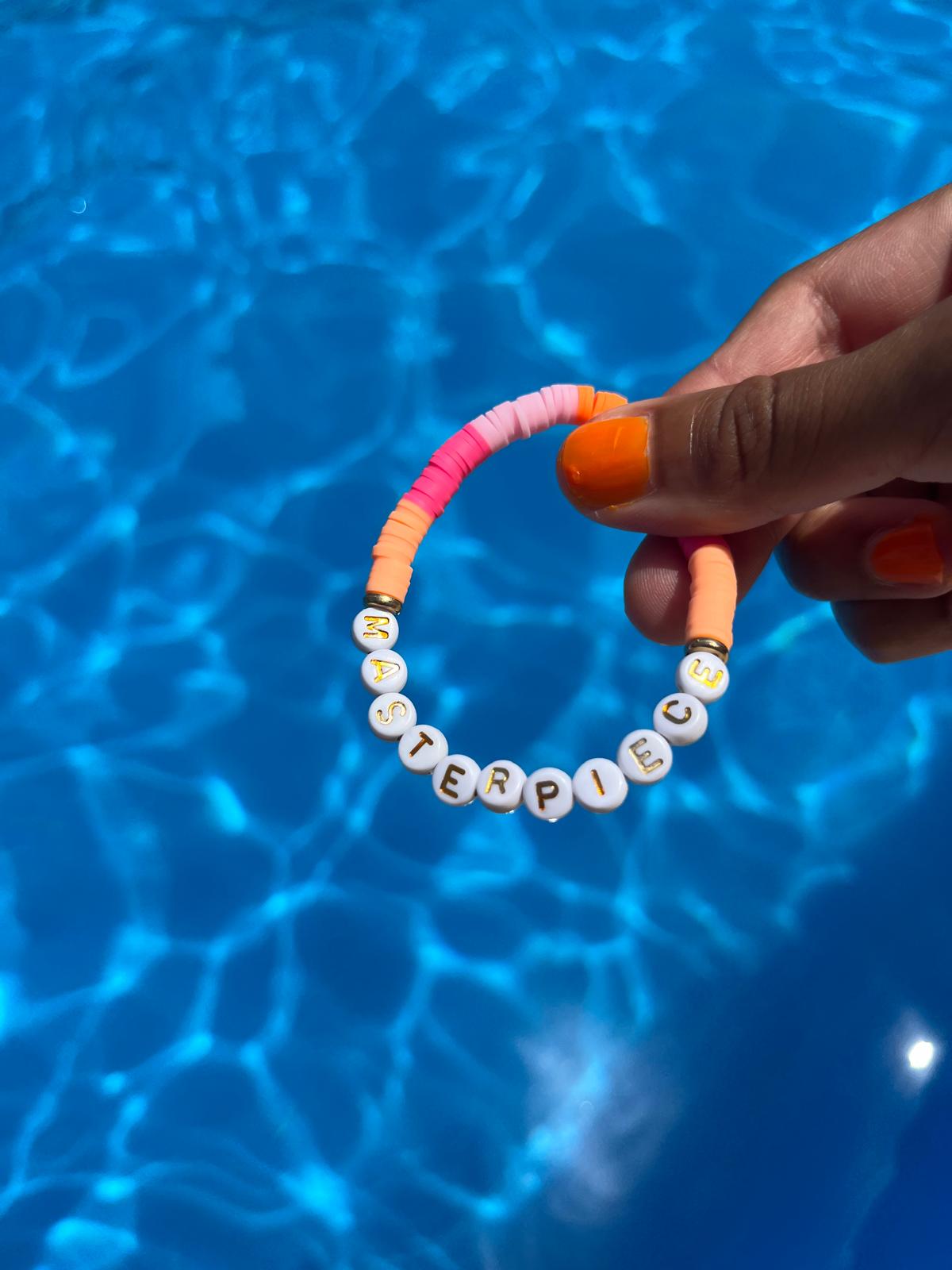MASTERPIECE slogan bracelet in orange/ pink