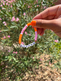 STRONG slogan bracelet in orange/ pink
